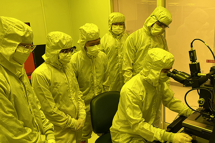A group of students in PPE gear in a clean room